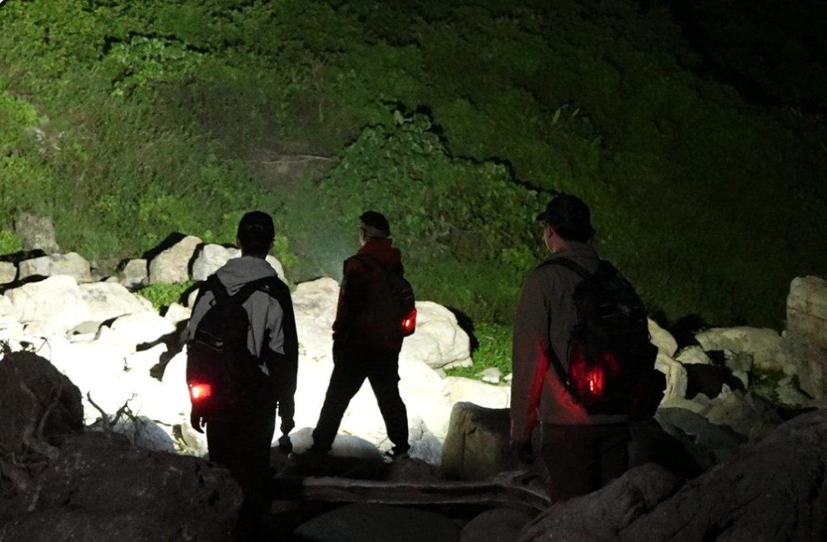 Acebeam X80GT 3 flood beam lighting a rocky outdoor trail at night. Official photo: Acebeam.